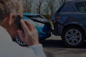 man on his phone calls after a car accident