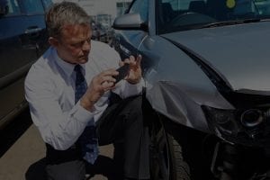 Man takes a photo of his damaged car